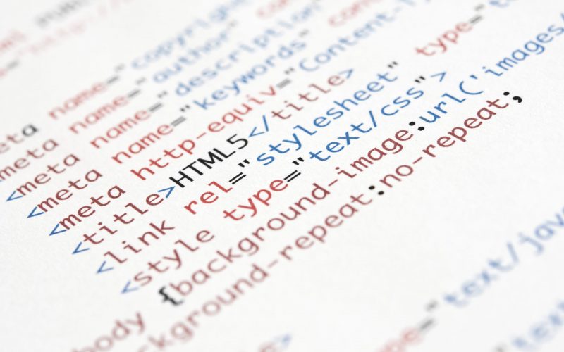 HTML script printed on white paper with shallow depth of field